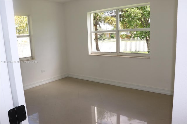 unfurnished room with tile patterned floors