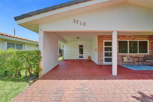 property entrance with a patio