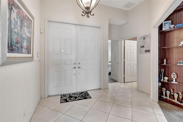 entryway with light tile patterned flooring