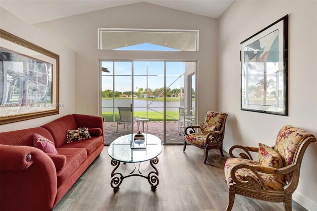 living room featuring light hardwood / wood-style flooring and lofted ceiling