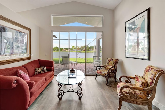 living room featuring vaulted ceiling and light wood-type flooring