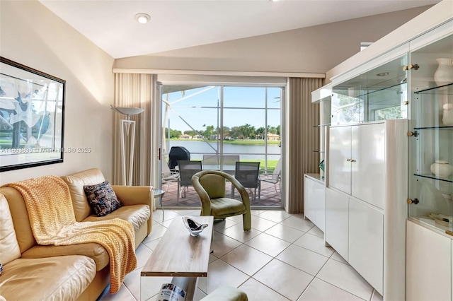 tiled living room with a water view and lofted ceiling