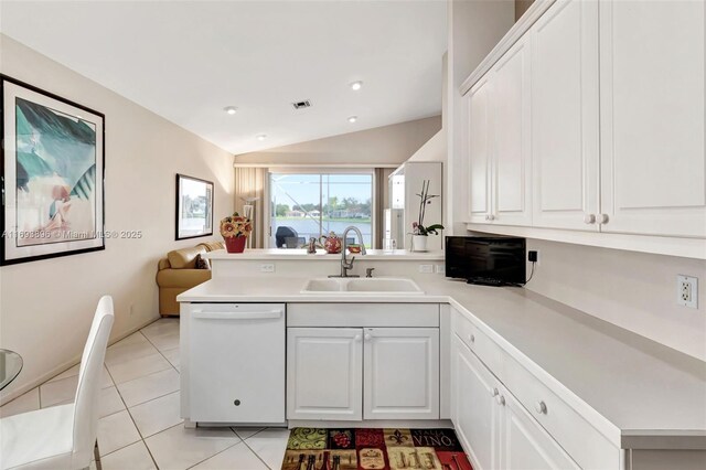 kitchen with kitchen peninsula, sink, white cabinets, and white dishwasher