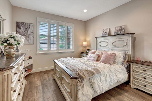 bedroom with dark hardwood / wood-style floors