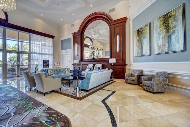 interior space with coffered ceiling, a high ceiling, ornamental molding, and a healthy amount of sunlight