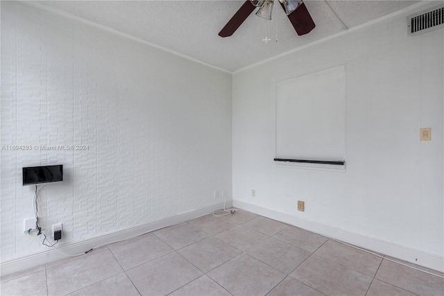 tiled spare room featuring a textured ceiling and ceiling fan