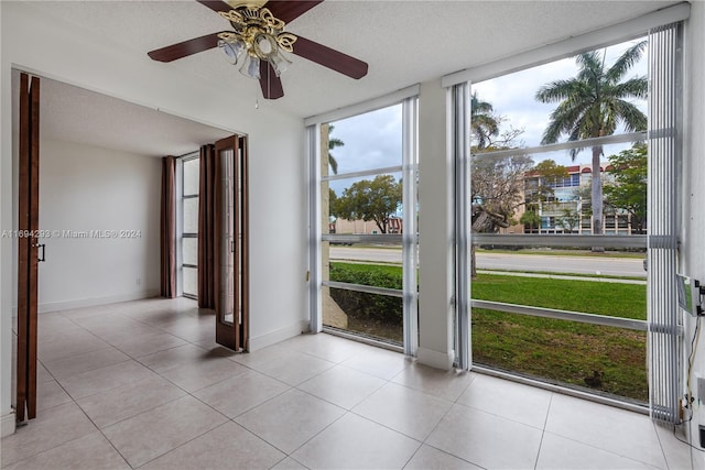 2000 Atlantic Shores Blvd Unit 107, Hallandale Beach, FL 33009 - empty room with a ceiling fan, light tile patterned flooring, a textured ceiling, and baseboards