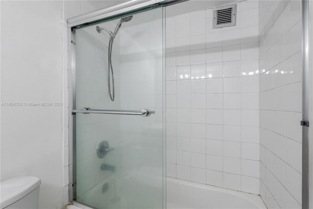 2000 Atlantic Shores Blvd Unit 107, Hallandale Beach, FL 33009 - bathroom featuring enclosed tub / shower combo and toilet