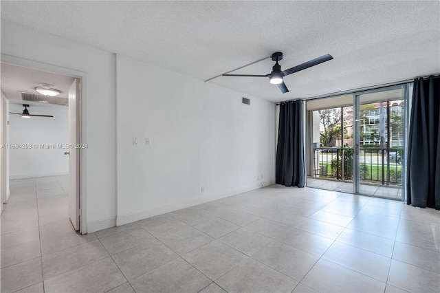 2000 Atlantic Shores Blvd Unit 107, Hallandale Beach, FL 33009 - spare room featuring ceiling fan, a textured ceiling, light tile patterned floors, and floor to ceiling windows