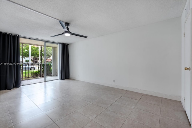 2000 Atlantic Shores Blvd Unit 107, Hallandale Beach, FL 33009 - spare room featuring a ceiling fan, light tile patterned floors, and a textured ceiling