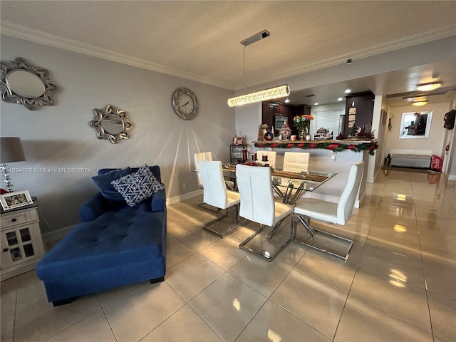 tiled dining space featuring crown molding