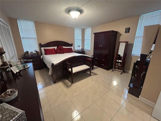 tiled bedroom featuring a textured ceiling