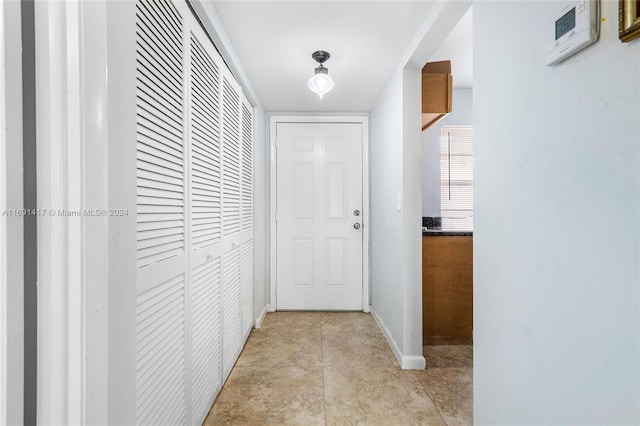 hall with light tile patterned floors