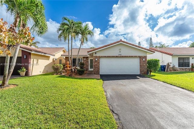 single story home featuring a front lawn and a garage