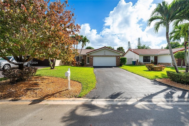 view of front of property with a front lawn and a garage