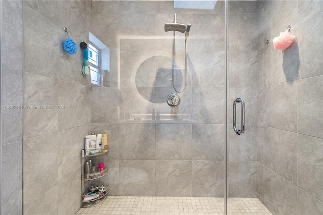 bathroom with a shower with door