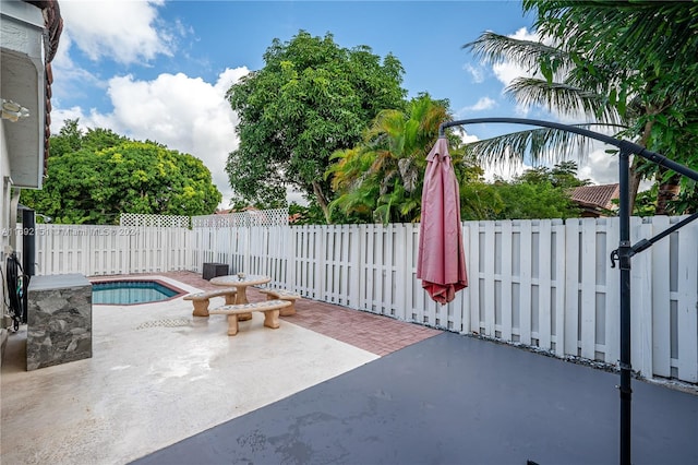 view of patio with a fenced in pool