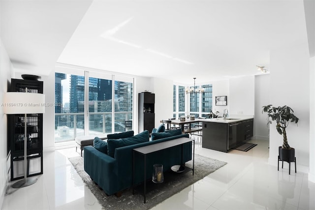 living room with a chandelier, light tile patterned floors, a healthy amount of sunlight, and sink