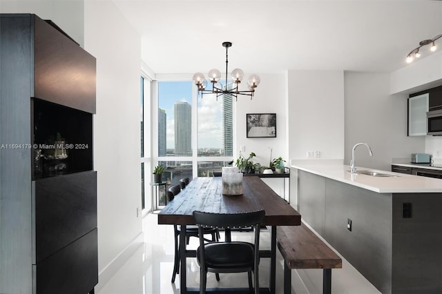 dining area featuring floor to ceiling windows, sink, and a notable chandelier