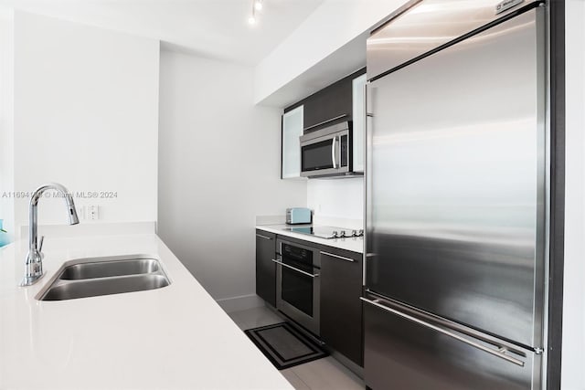 kitchen with sink, light tile patterned floors, and stainless steel appliances