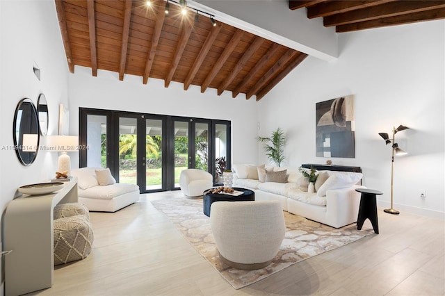 living room featuring beam ceiling, french doors, high vaulted ceiling, light hardwood / wood-style floors, and wood ceiling