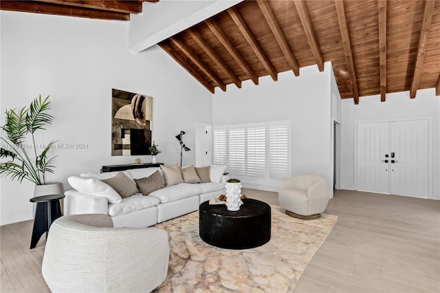 living room featuring beam ceiling, high vaulted ceiling, and light hardwood / wood-style flooring