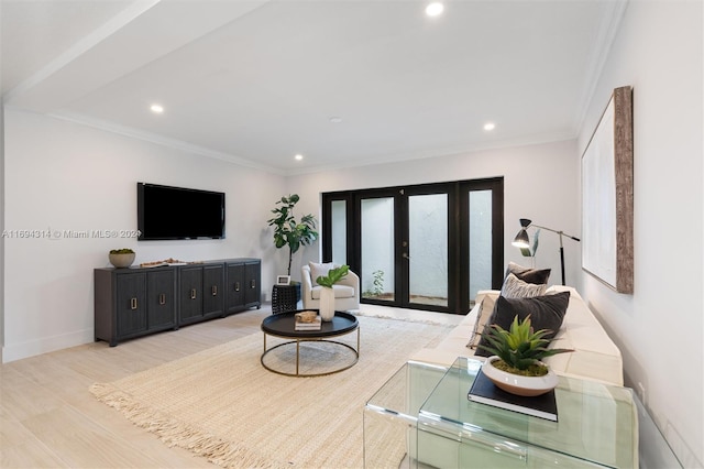 living room with french doors, crown molding, and light hardwood / wood-style flooring