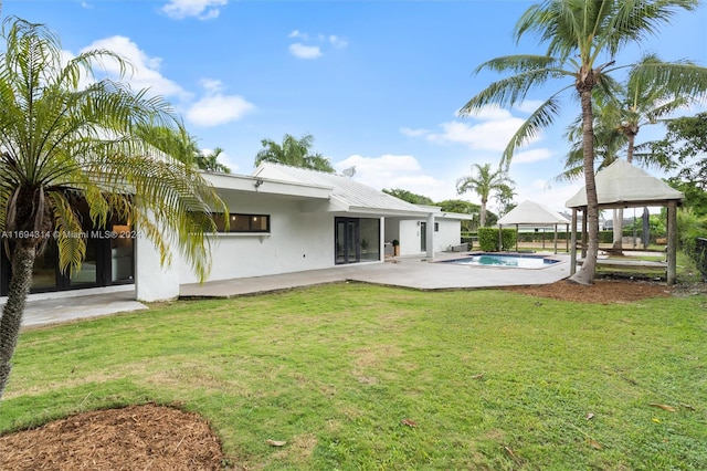 back of house with a gazebo, a patio area, and a yard