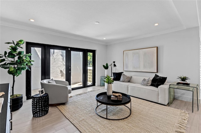 living room with light hardwood / wood-style floors and ornamental molding