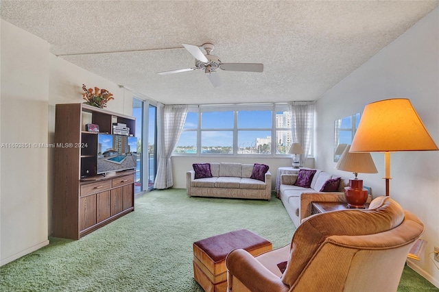 living room with ceiling fan, carpet, and a textured ceiling