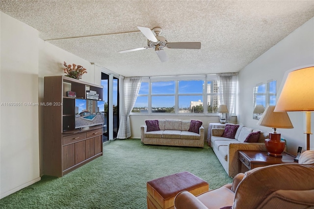 carpeted living room with a textured ceiling, ceiling fan, and a healthy amount of sunlight