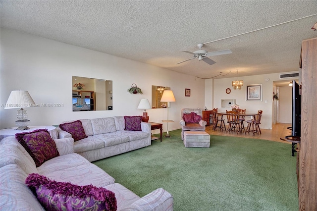 living room with carpet flooring, a textured ceiling, and ceiling fan