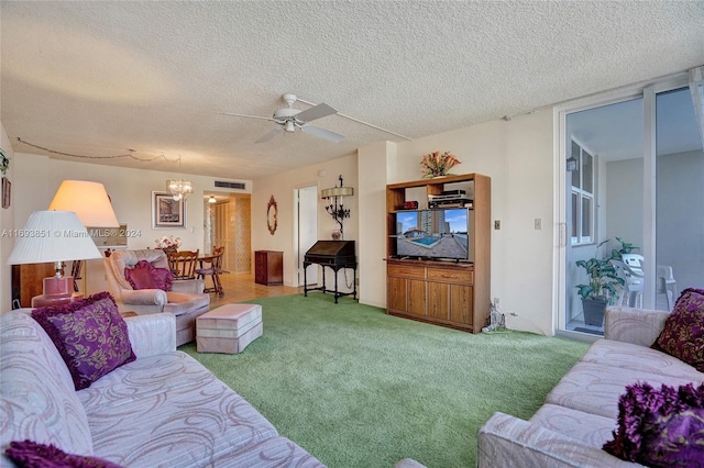 living room with carpet flooring, a textured ceiling, and ceiling fan with notable chandelier