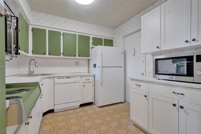 kitchen with a textured ceiling, white cabinetry, sink, and white appliances