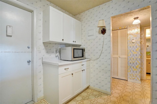 kitchen featuring white cabinetry