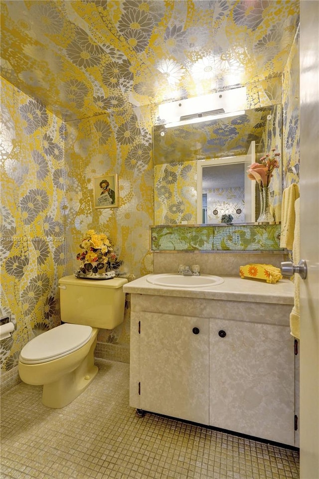 bathroom featuring tile patterned floors, vanity, and toilet