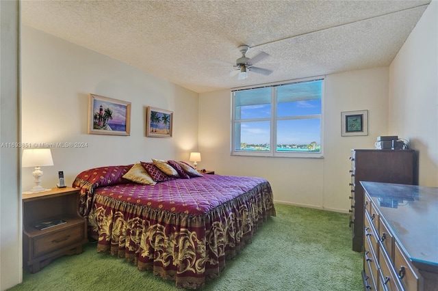 bedroom with carpet, a textured ceiling, and ceiling fan