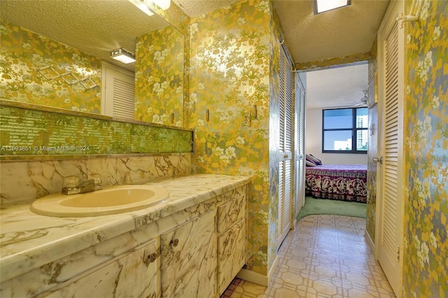 bathroom featuring sink and a textured ceiling