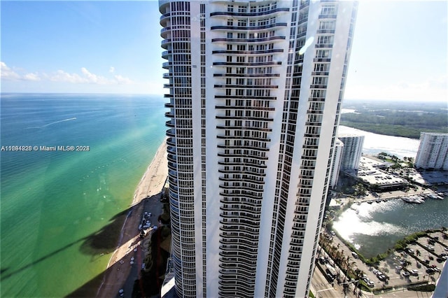 view of building exterior featuring a water view and cooling unit