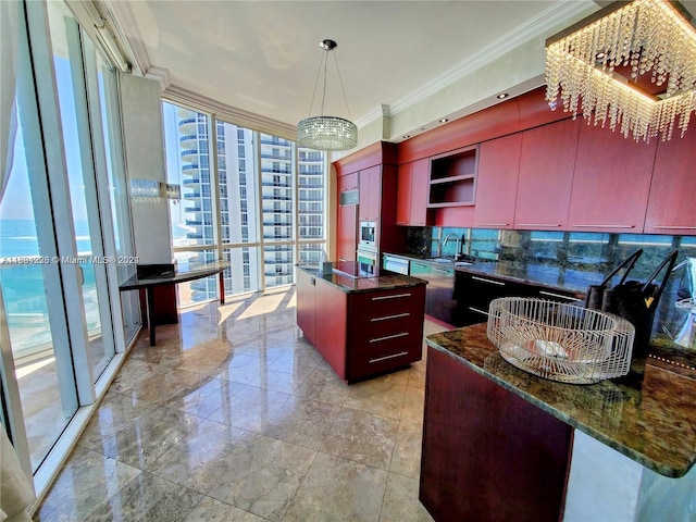 kitchen with a kitchen island, crown molding, a wealth of natural light, and tasteful backsplash