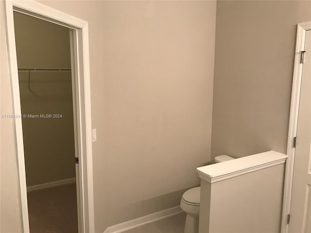 bathroom with tile patterned flooring and toilet