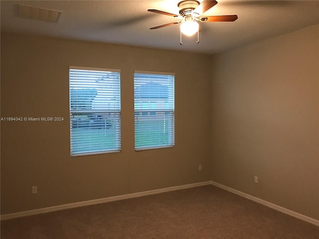 spare room featuring ceiling fan and carpet floors