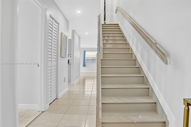 stairway with tile patterned floors