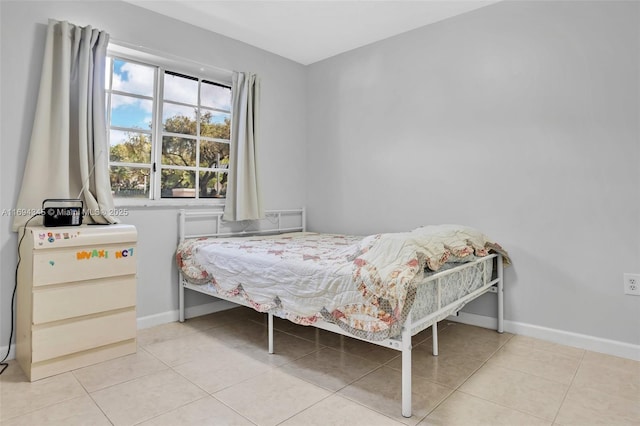 bedroom with light tile patterned floors