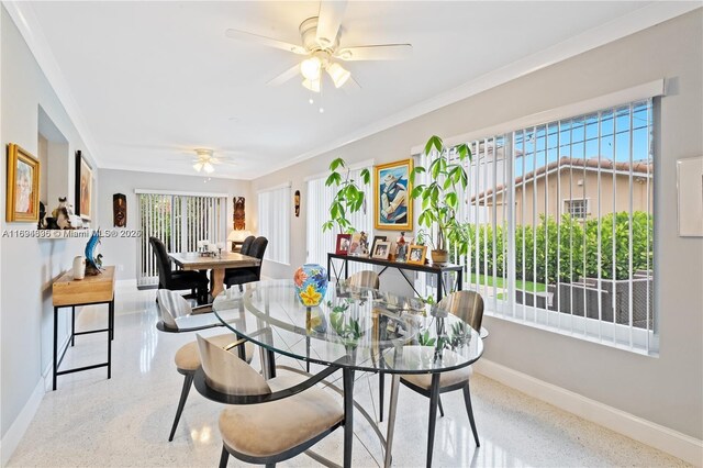 dining space with ceiling fan and ornamental molding