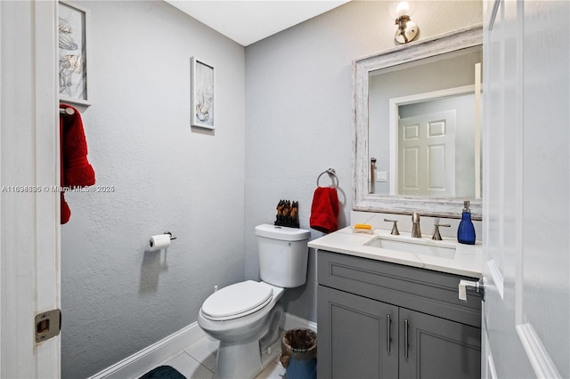 bathroom featuring tile patterned flooring, vanity, and toilet