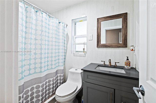 bathroom featuring vanity and toilet