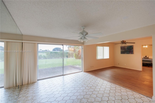 interior space with wood-type flooring, a textured ceiling, and ceiling fan