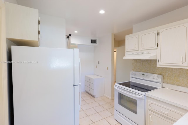 kitchen with white cabinets, light tile patterned floors, white appliances, and tasteful backsplash