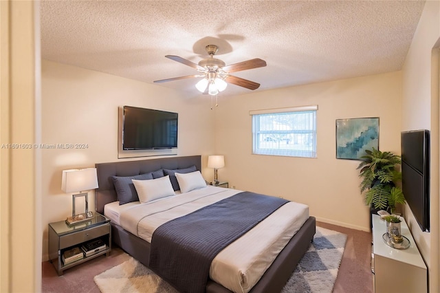 bedroom with carpet, ceiling fan, and a textured ceiling